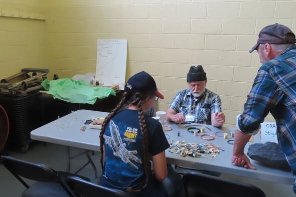 A club member teaching kids about minerals