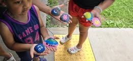 Kids painting rocks and shells at craft day