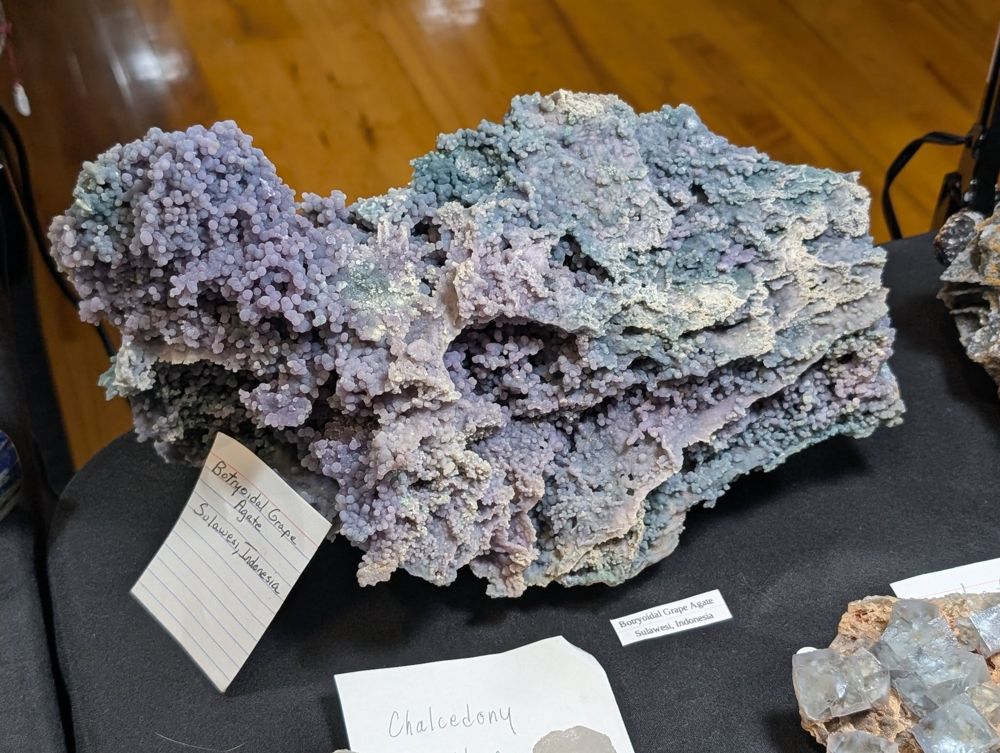 A large botryoidal grape agate specimen from Sulawesi, Indonesia, on a dealer's table
