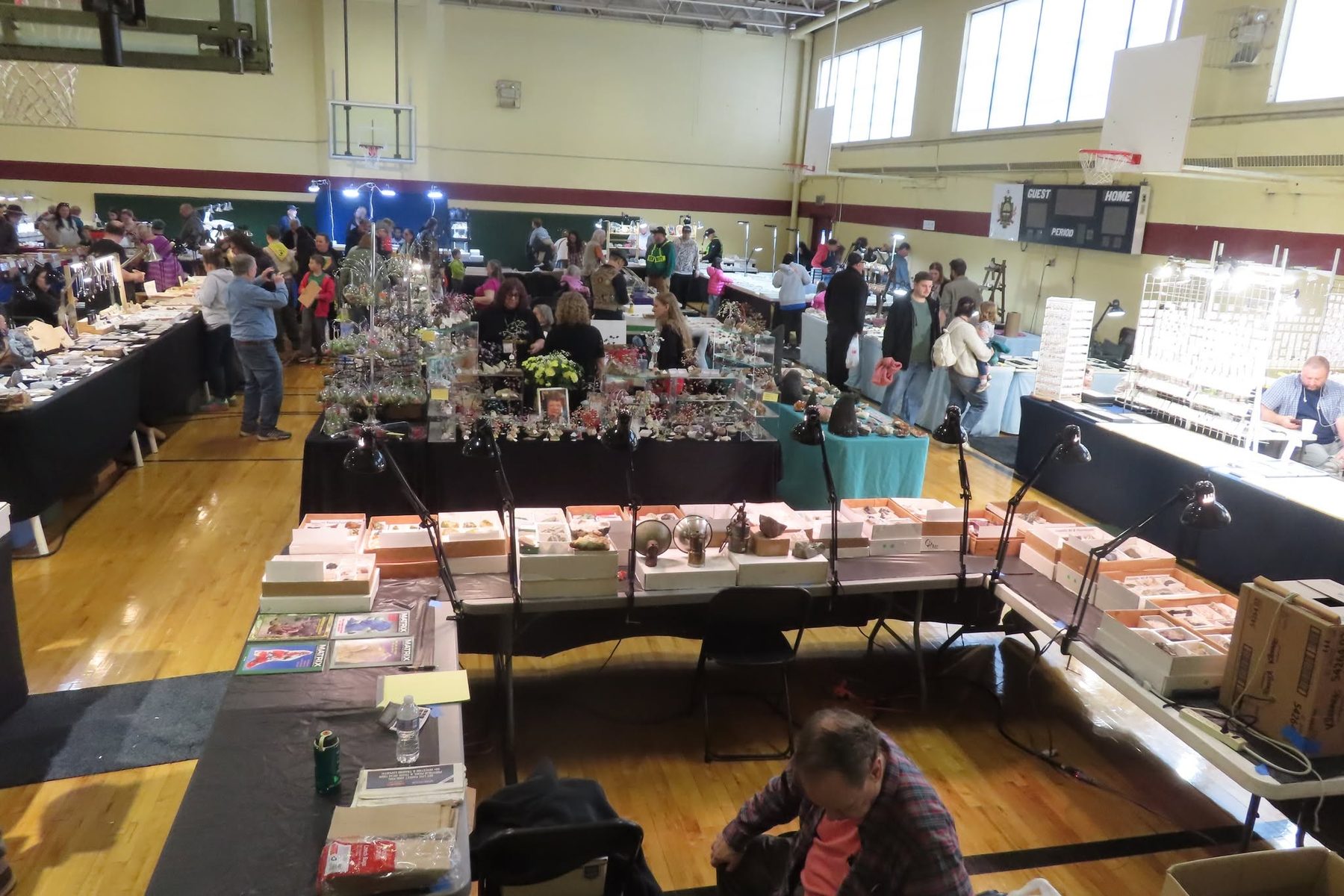 An elevated view of the busy show floor with dealer tables and visitors